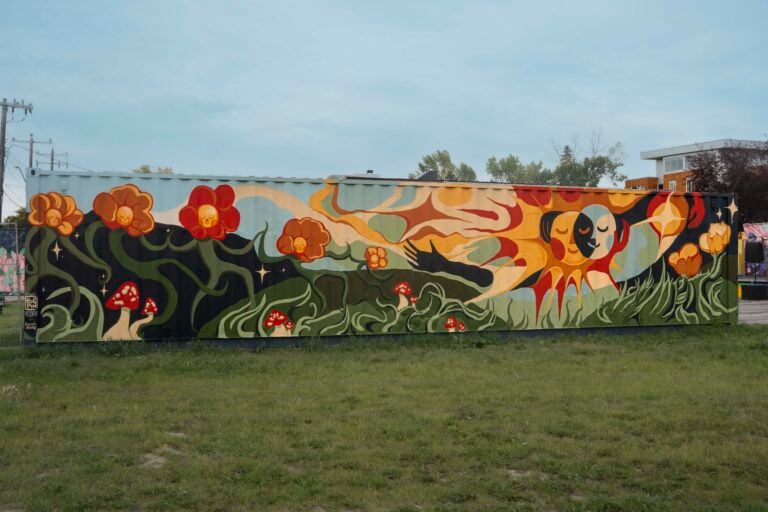 A photograph of a colourful, nature inspired mural titled "How Love Flows" by youth artists Zia, Elizaveta, Asher, Jan, Q